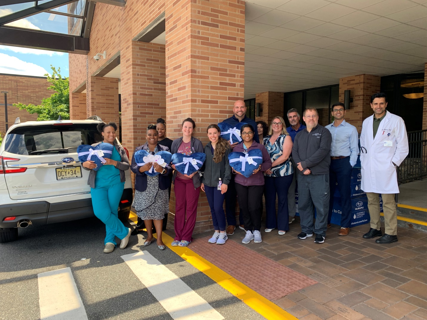 Photo of staff holding blankets