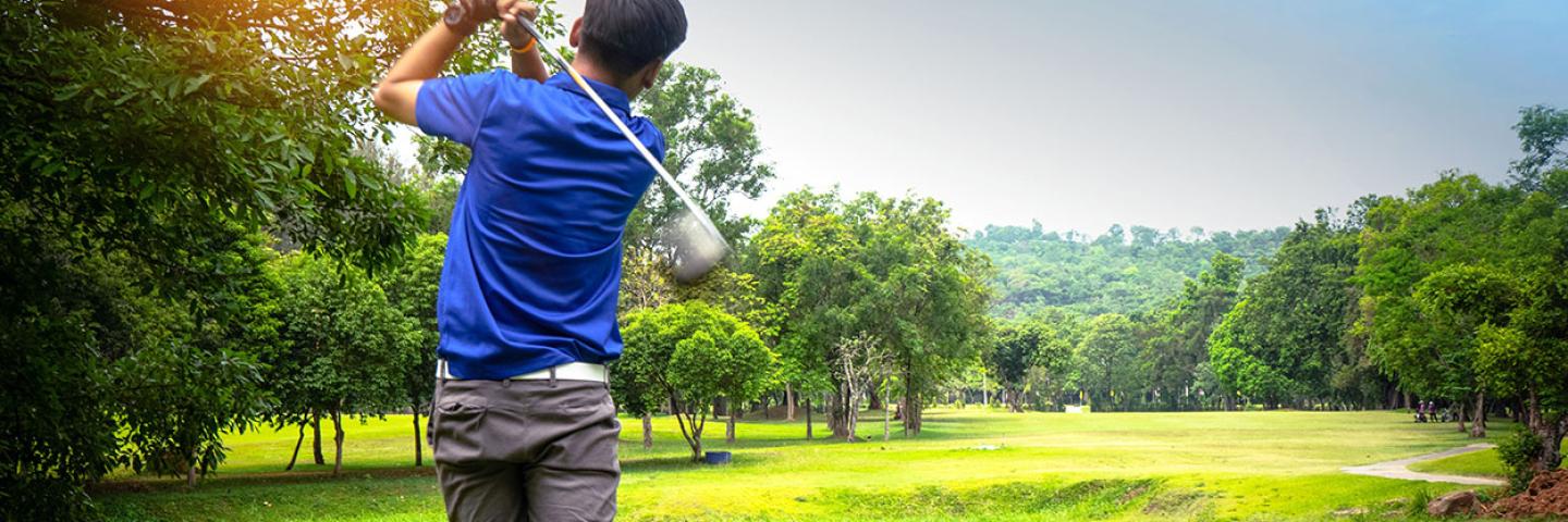 Male golfer swinging a club