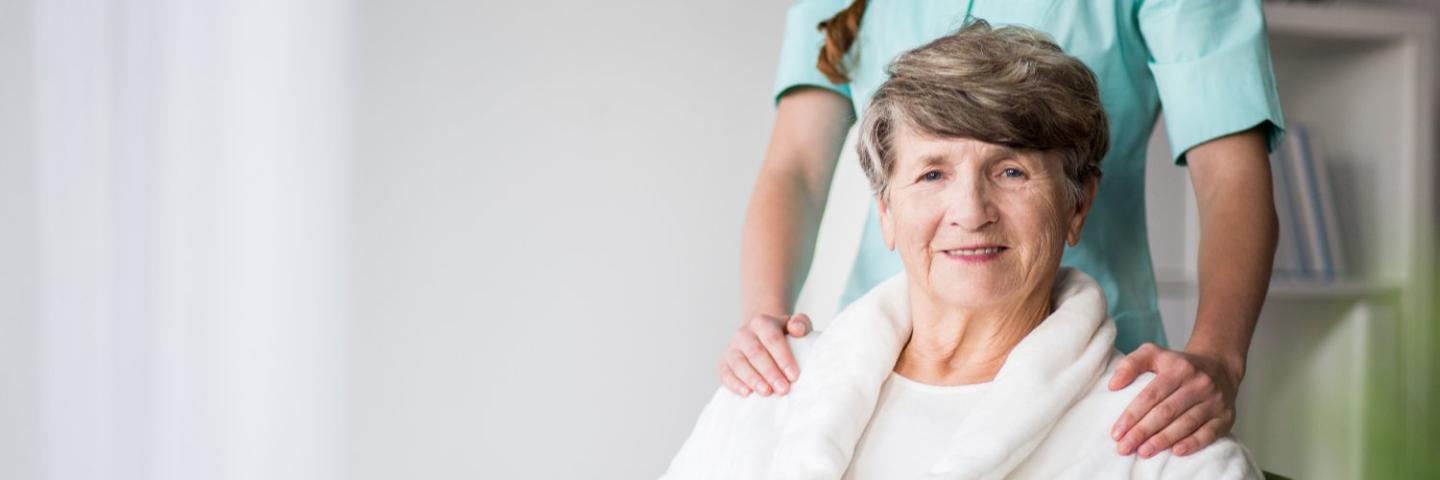 Home Health patient with nurse behind her