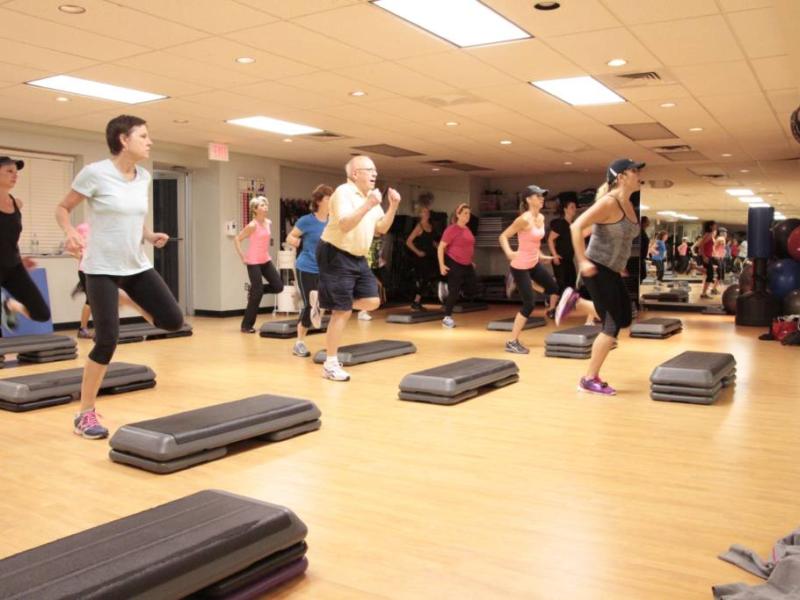 Photo of a group fitness class in aerobics studio class