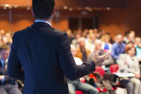 man facing audience speaking