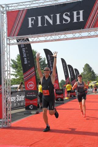 Larry running across finish line