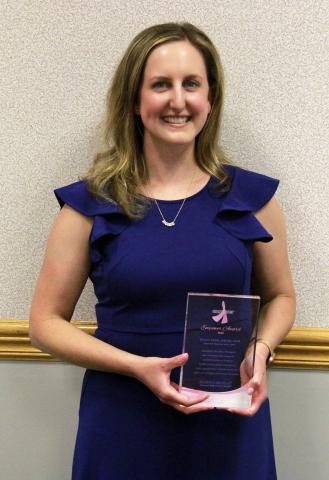 Jess Danik holding her Empower award.