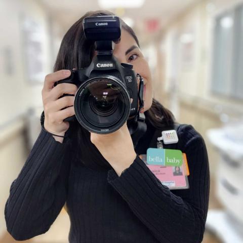 A picture of a photographer taking a photo with large camera in hand.