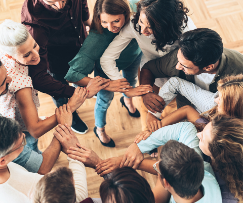 group of people linking arms in a circle