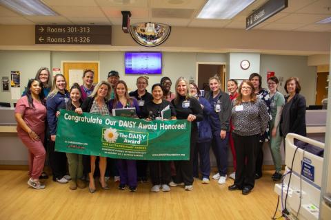 A photo of a group of people gathered to celebrate a nursing award. 